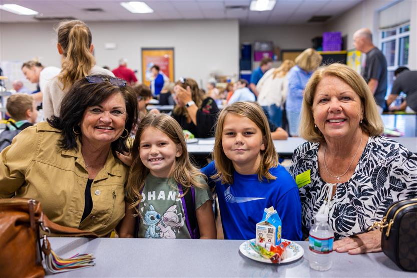 A family smiles at Winstead Elementary's Grandparents Breakfast